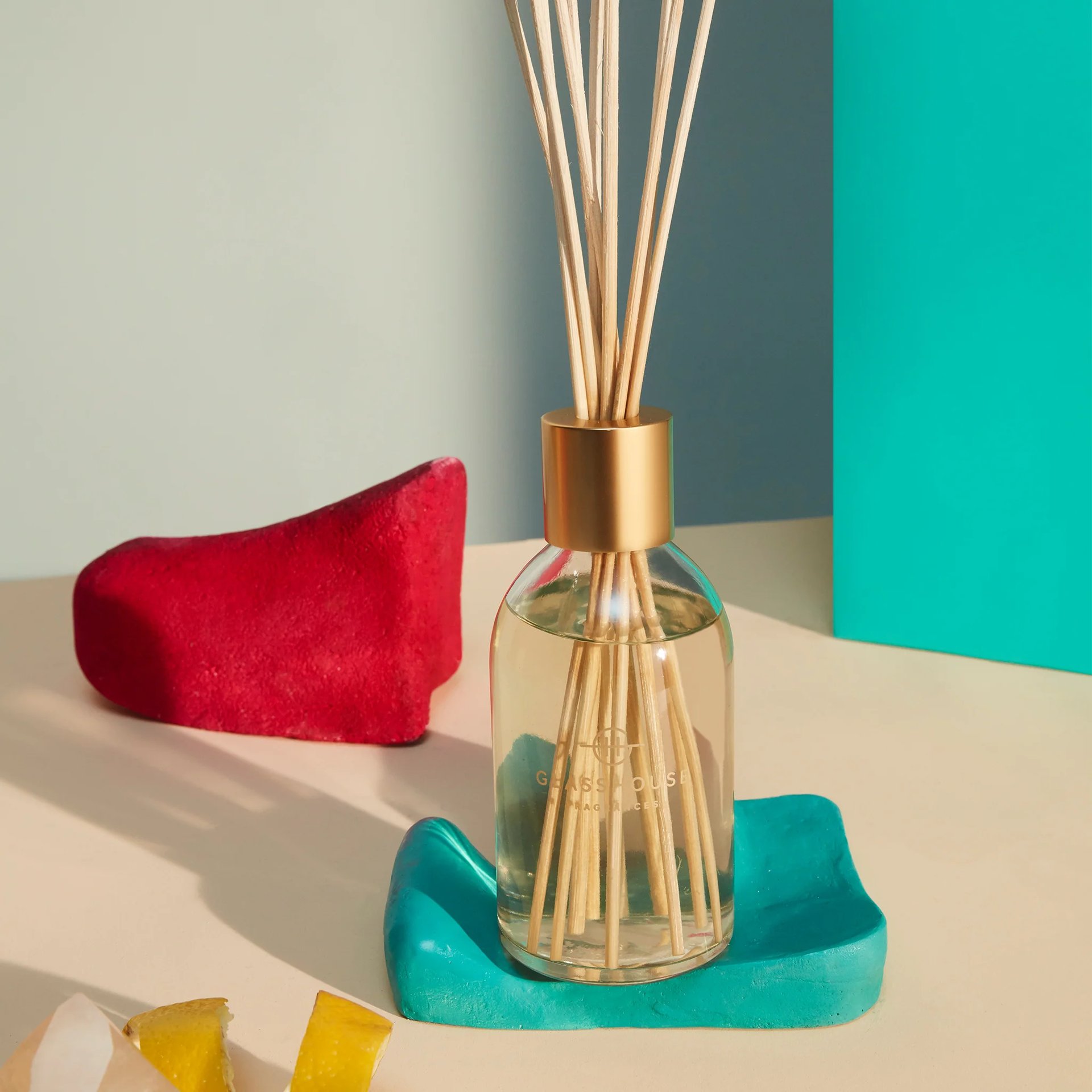 A Tahaa - Glasshouse Diffuser on a table next to a pair of shoes.